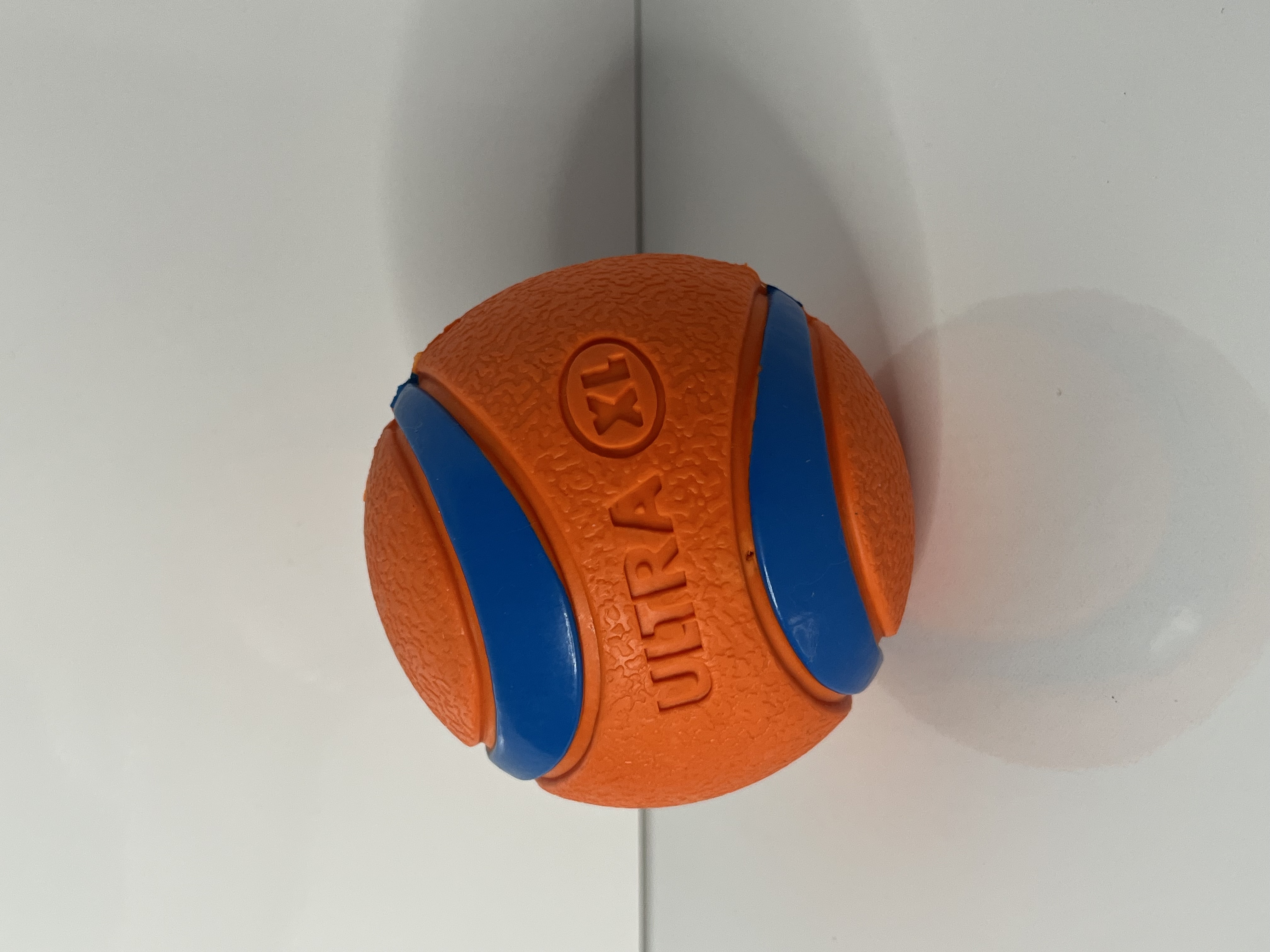 Another view of the ball captures its spherical form with clear emphasis on the alternating orange and blue bands.
