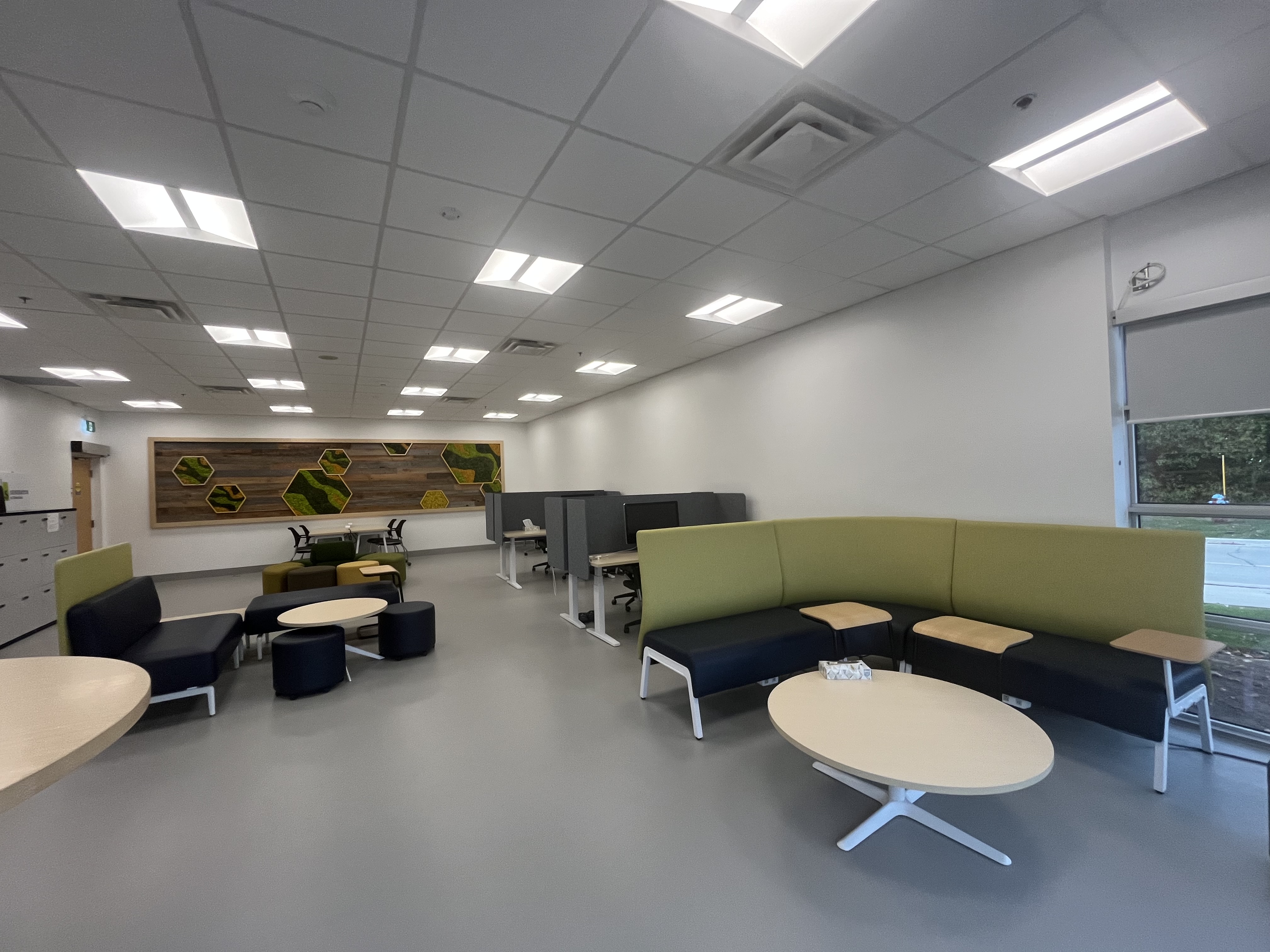 The studio environment combines lounge areas and focused work zones, creating a versatile layout for design and material experimentation.